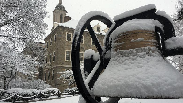 Snow falls on Old Main bell